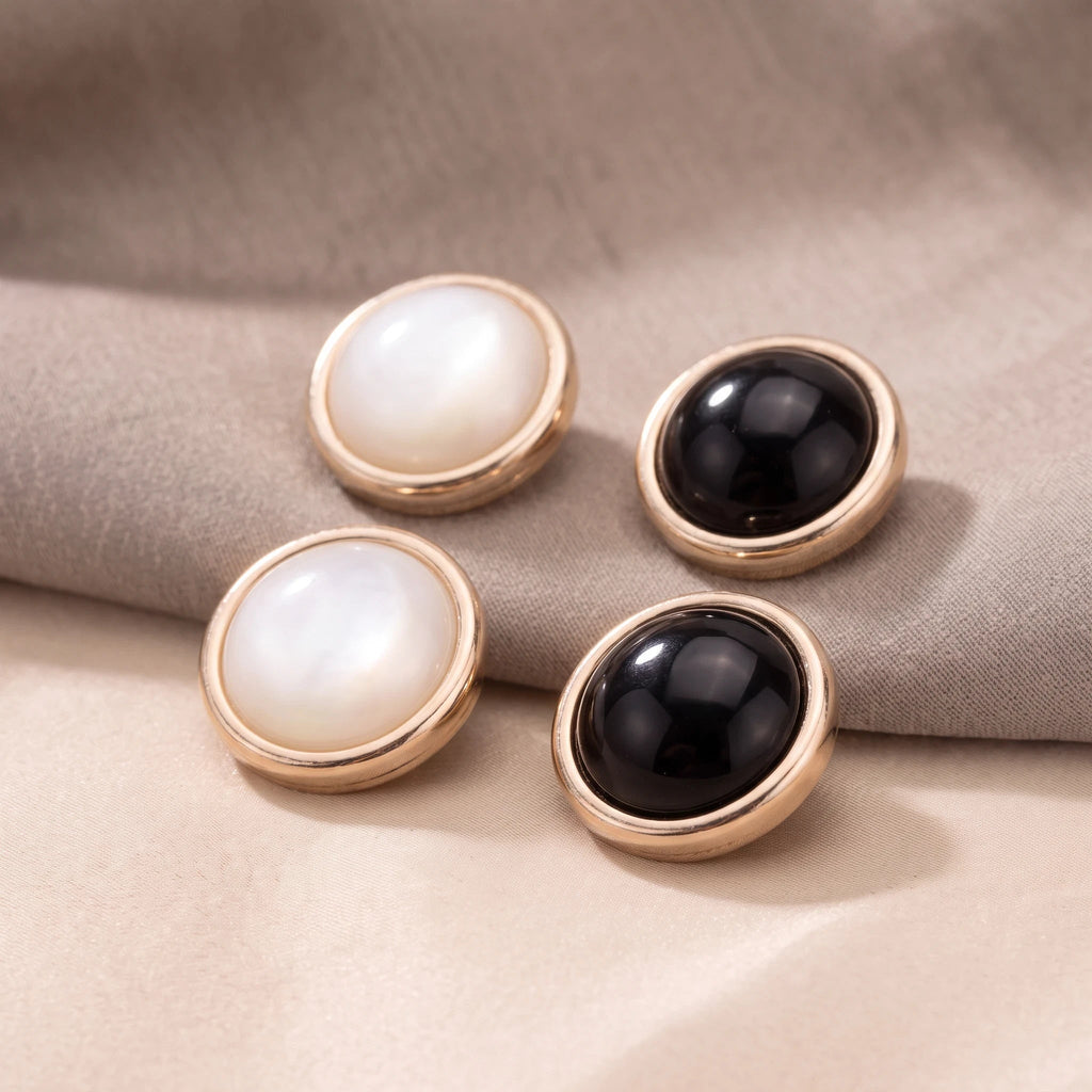 Eternal Aura Éclat hijab magnets in black and white with gold-toned round decorative frames on fabric