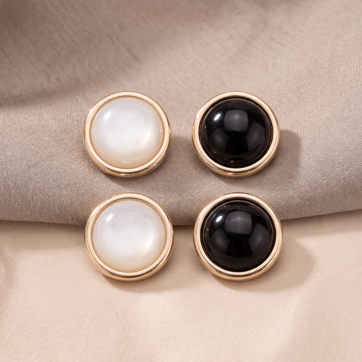 Eternal Aura Éclat hijab magnets featuring round white and black stones with elegant gold-toned metal rims