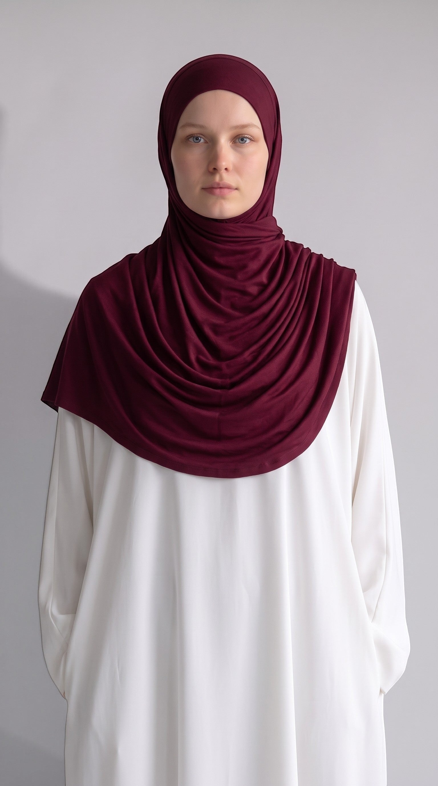 Eternal Aura jersey hijab in deep burgundy worn by a model in a white top, featuring soft and stretchy fabric.