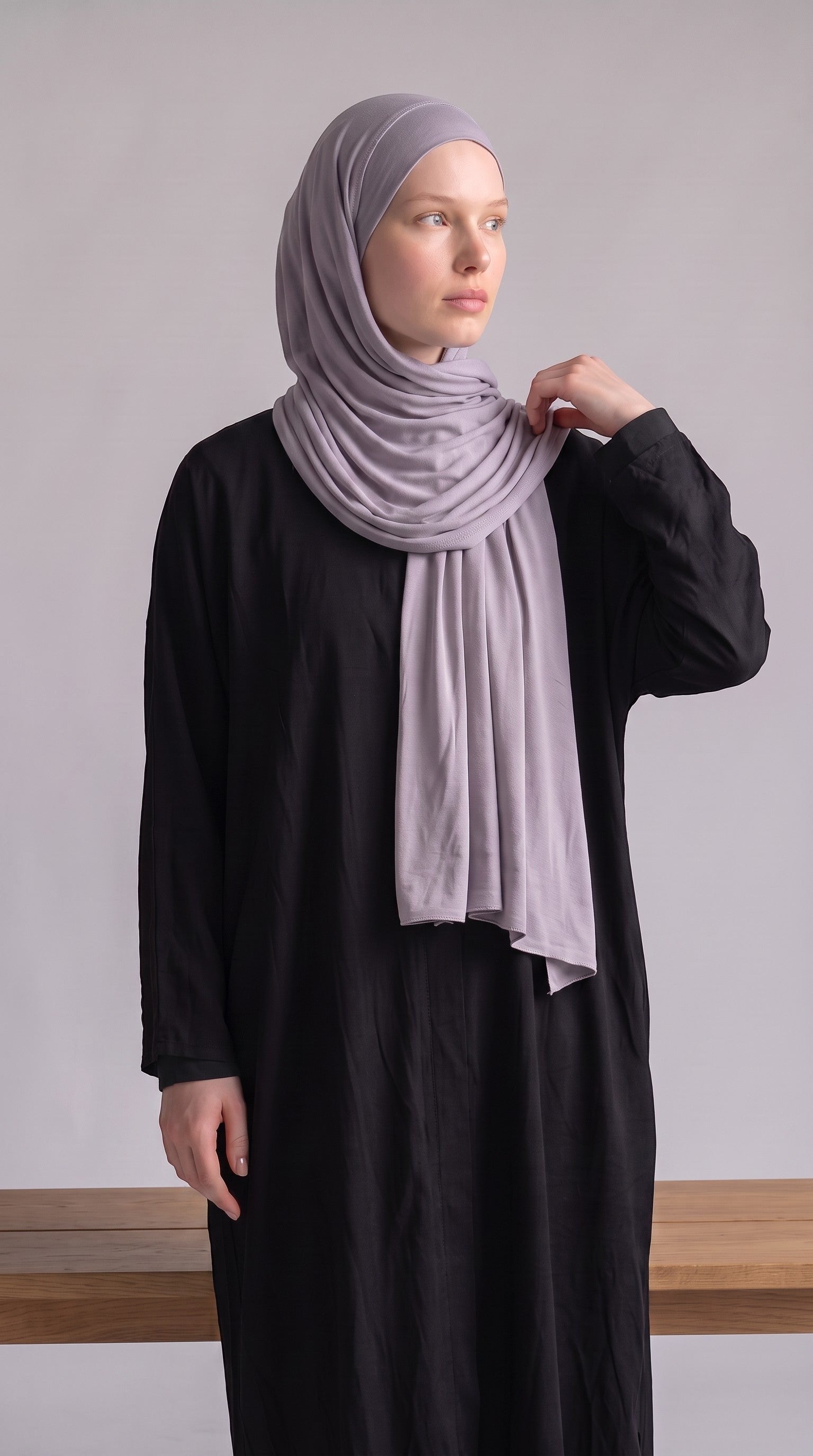 Eternal Aura soft lavender jersey hijab worn by a model in a black dress against a neutral background