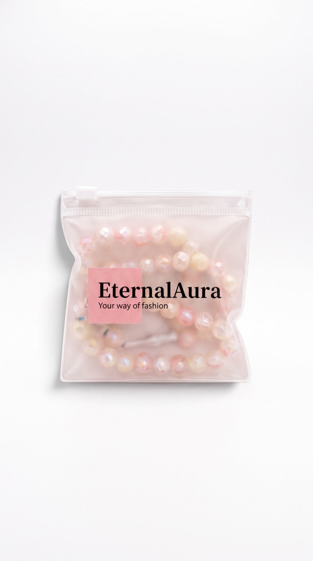 Eternal Aura Misbaha Gebetskette aus facettierten hellrosa und cremefarbenen Perlen in einer transparenten Tasche