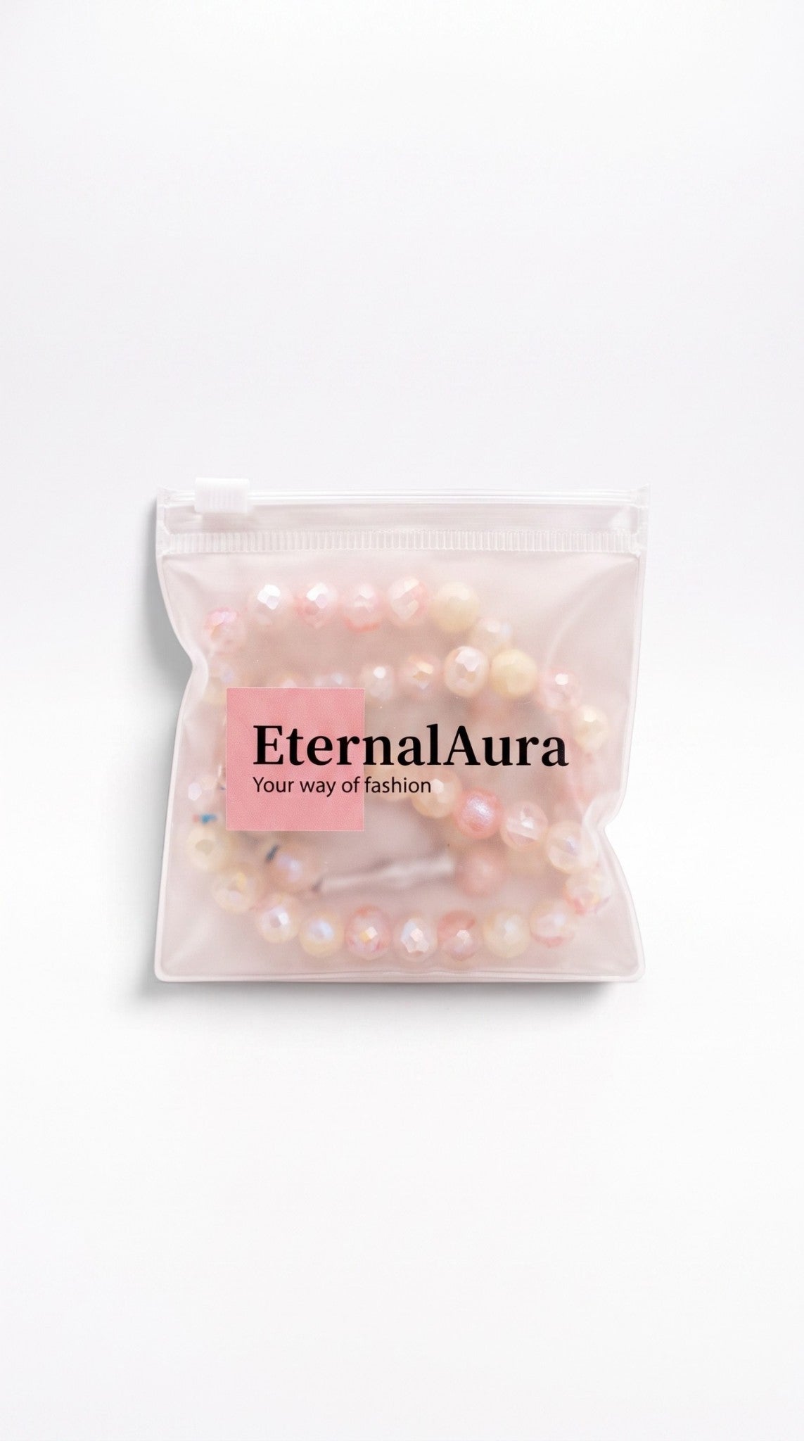 Eternal Aura Misbaha Gebetskette aus facettierten hellrosa und cremefarbenen Perlen in einer transparenten Tasche